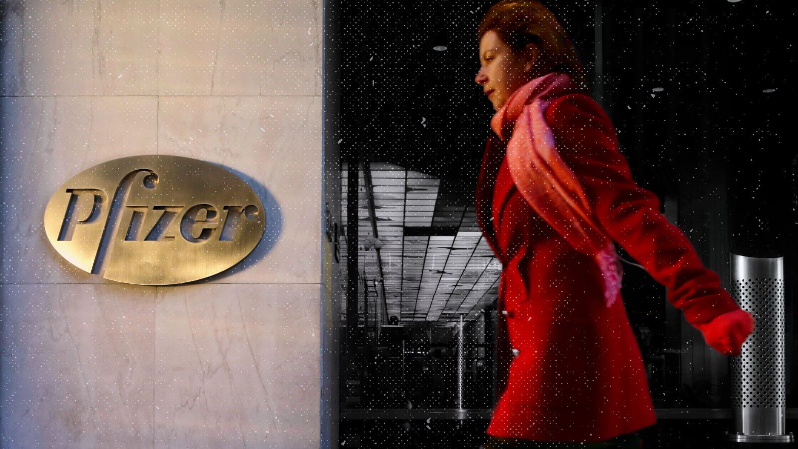 A woman walks past the Pfizer sign in front of Pfizer's world headquarters in New York.