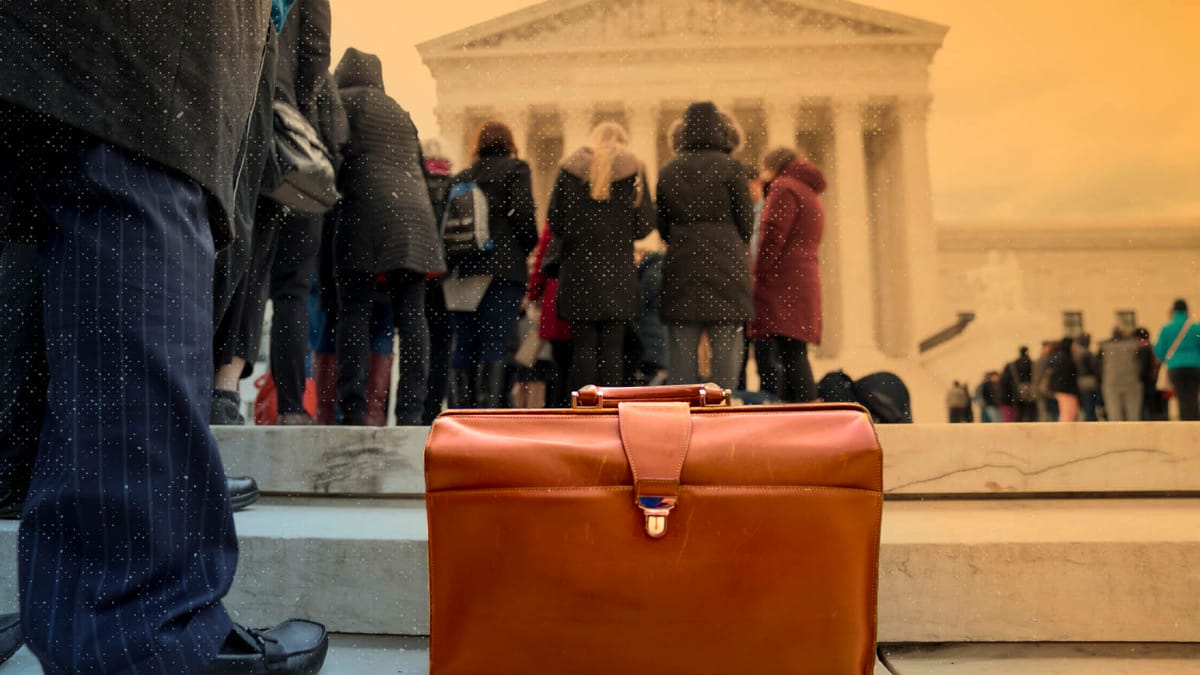 A suitcase sits on steps leading to the Supreme Court building.