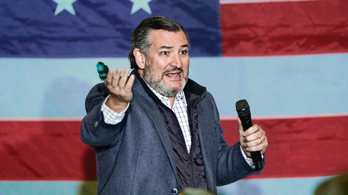 Ted Cruz giving a campaign speech in front of an American flag.