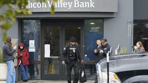 A Brinks worker exits Silicon Valley Bank on Friday, March 10, 2023. (AP Photo/Jeff Chiu)